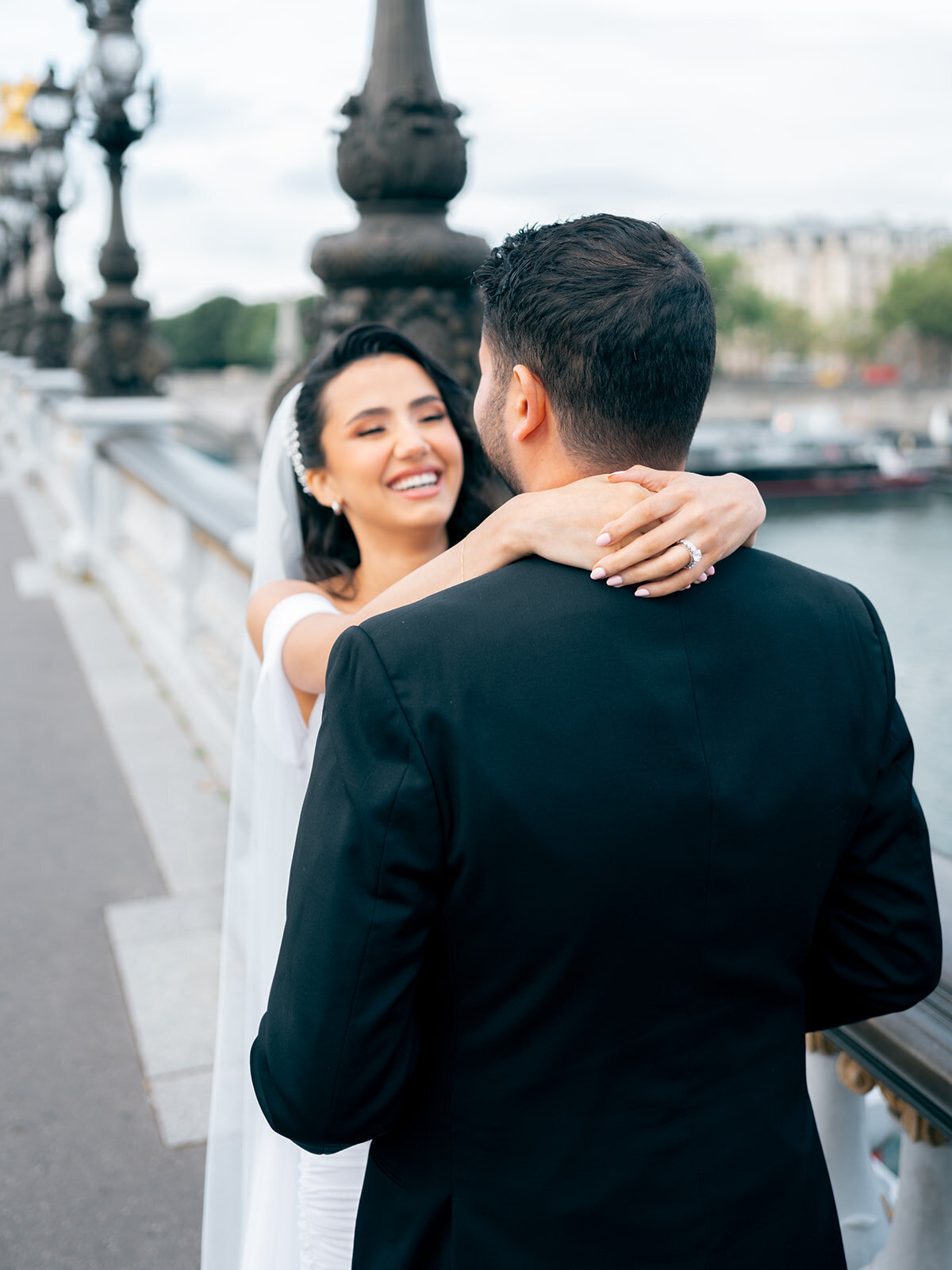 Bride smiling with her arms around her husband's neck