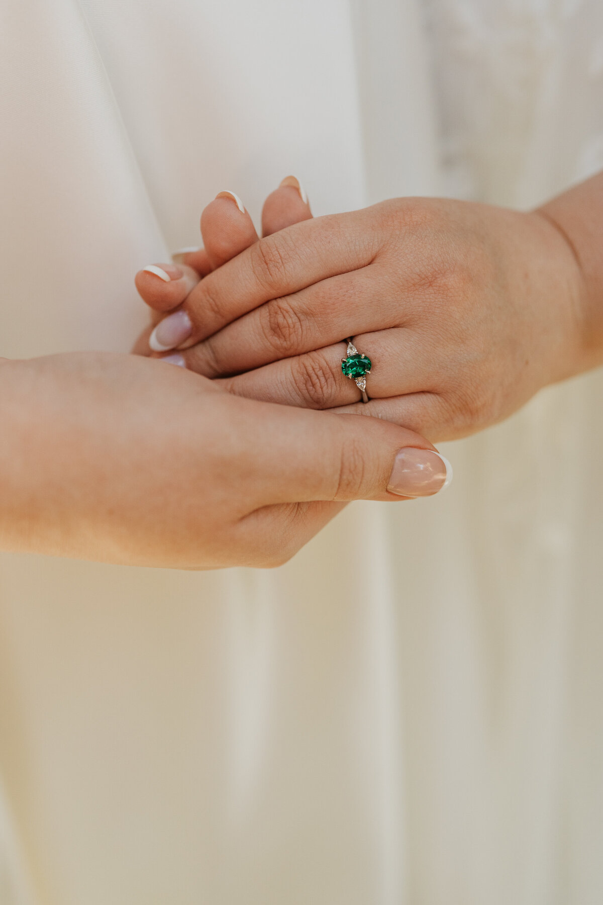 Two hands being held showing off an engagement ring 