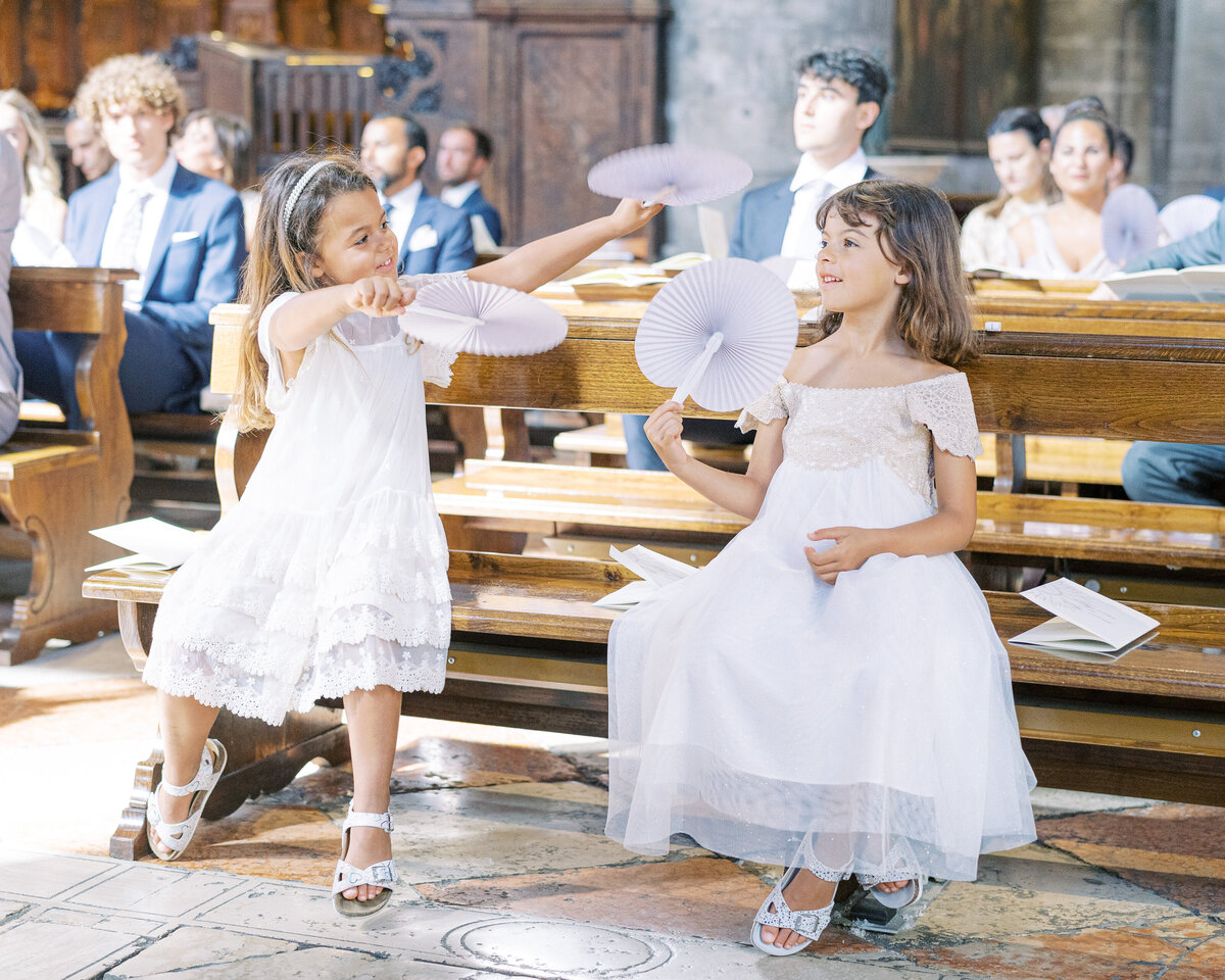Flower girls playing in church wedding in Venice