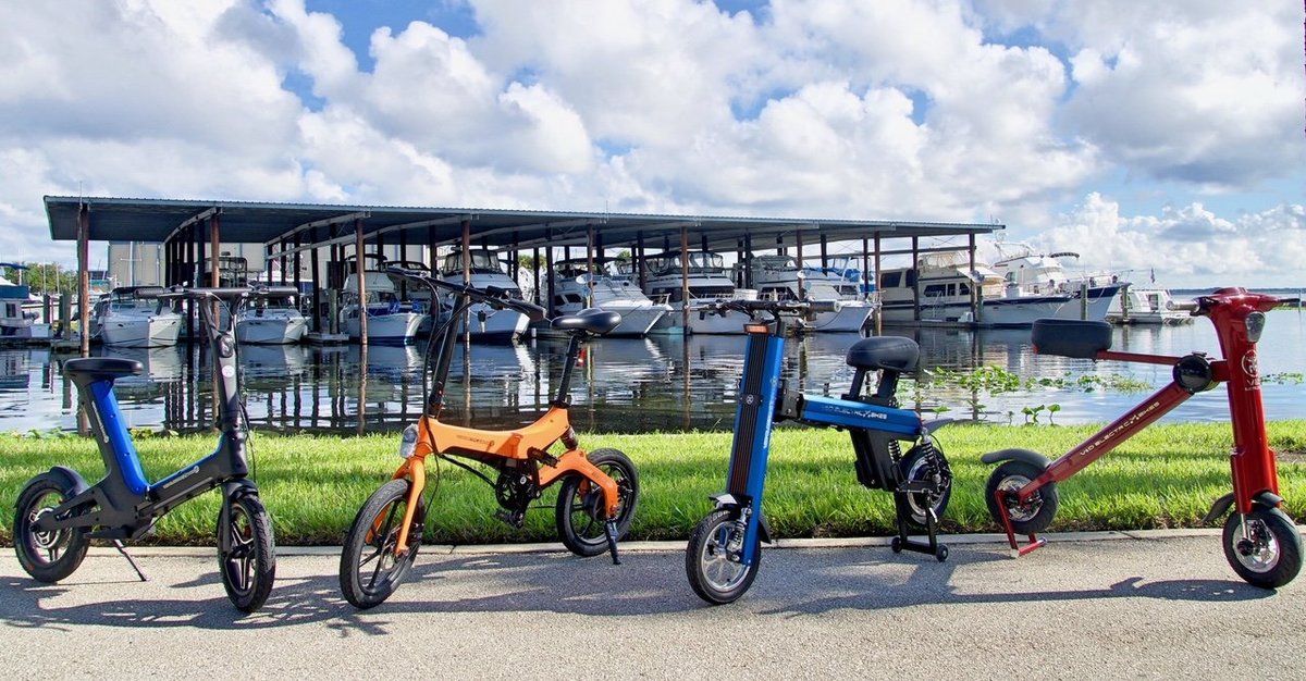 Blue Go-Bike M3 & Orange Go-Bike M4 with boat dock in background, V&D Electric Bikes