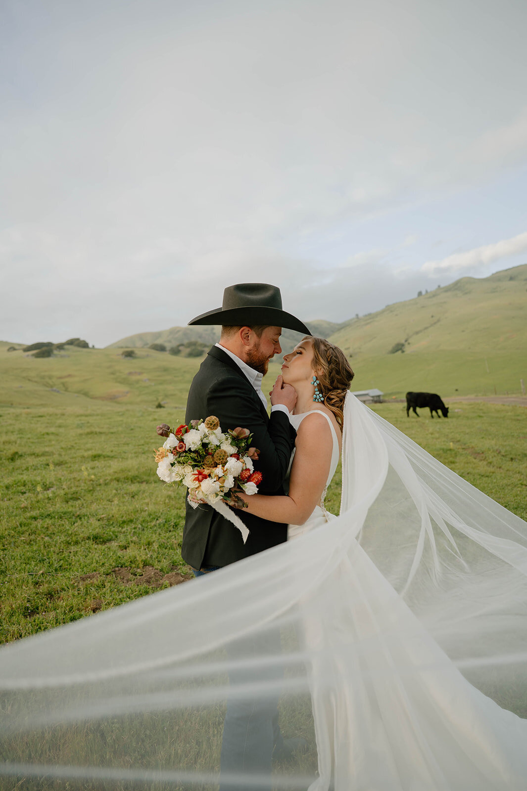 bride-groom-long-veil-ranch-kiss