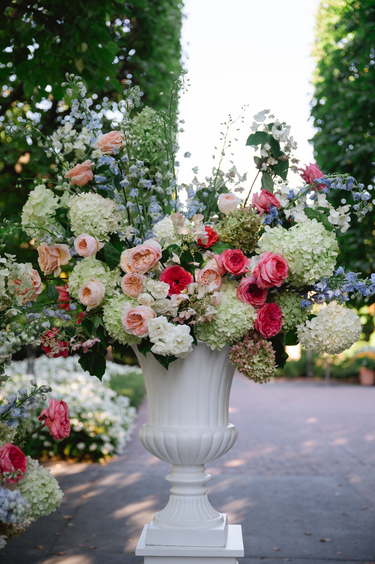 Elegant floral arrangement in a white vase at a wedding venue in the Chicago Botanic Gardens.
