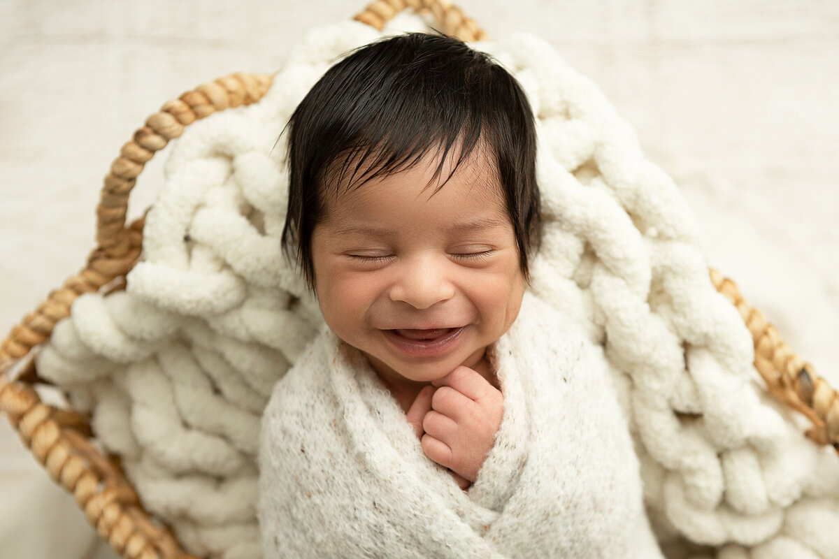 columbus-ohio-newborn-baby-boy-swaddled-in-white-with-big-smile