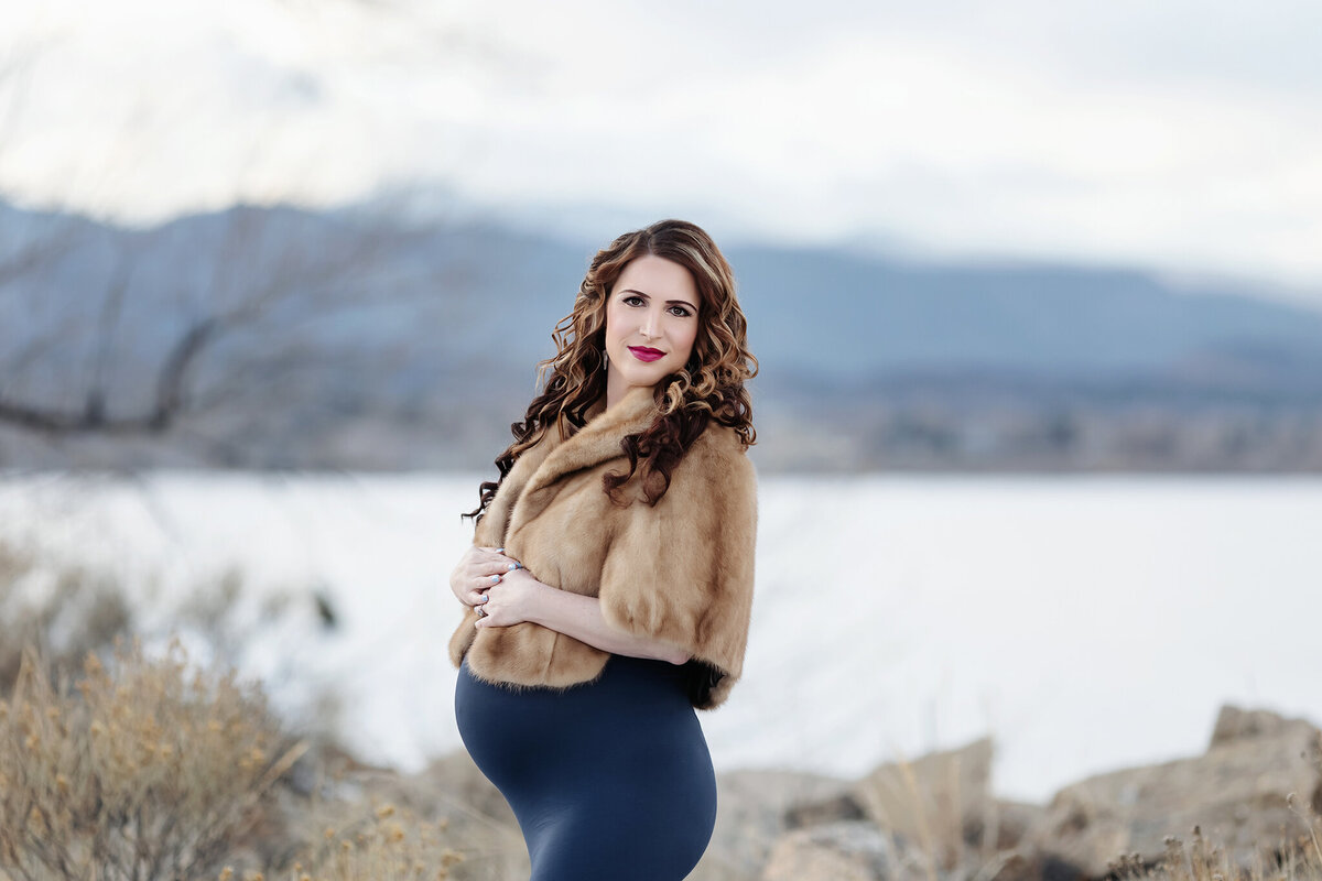 winter maternity photos in loveland with snowy mountain backdrops