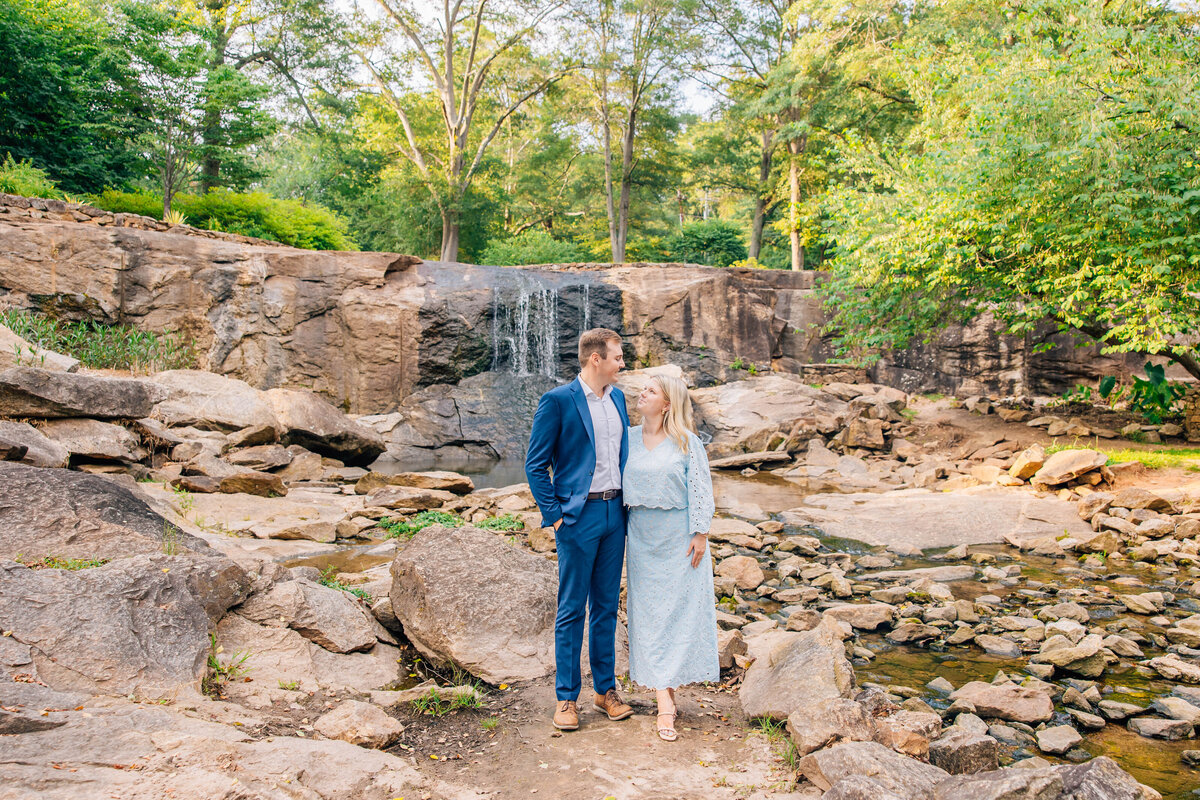 couple posing at rock area holding each other