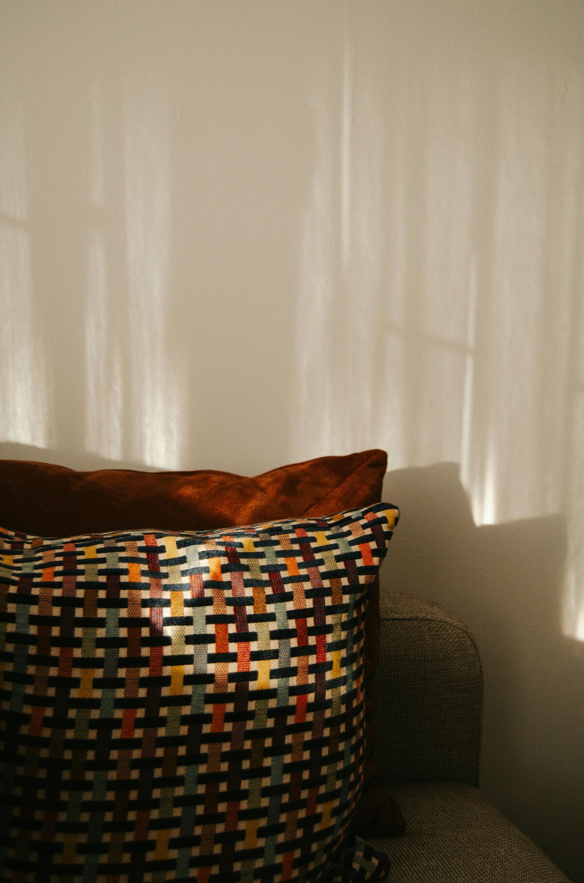 Cozy patterned pillows with sun and shadows