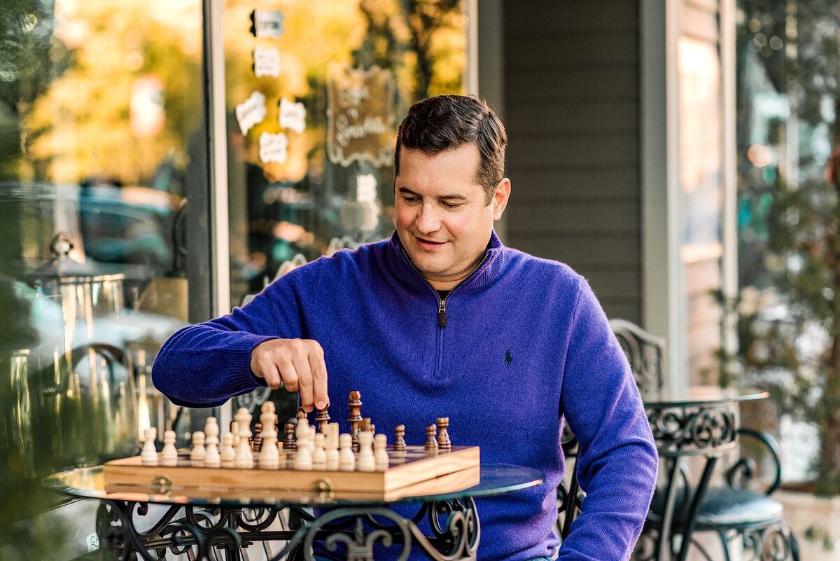 guy playing chess outside