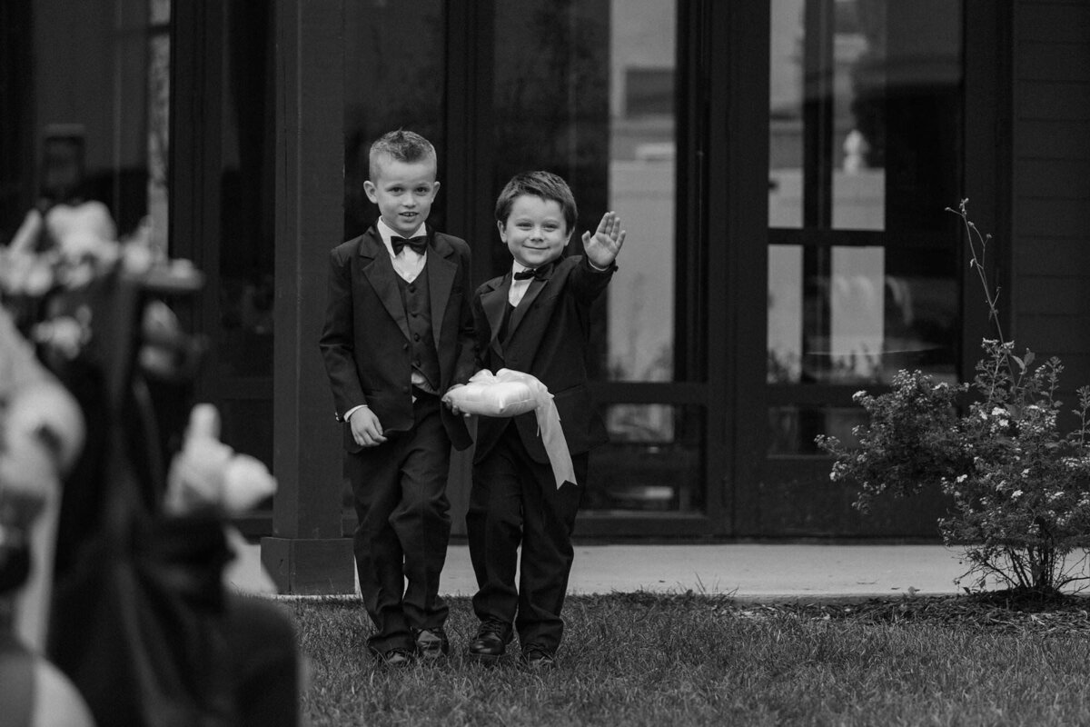 Two small kids walking down the aisle during a wedding 