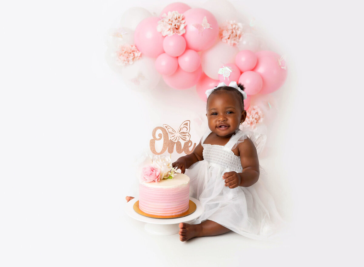 Baby girl pink and white ballon garland cake smash session in Brooklyn Ny