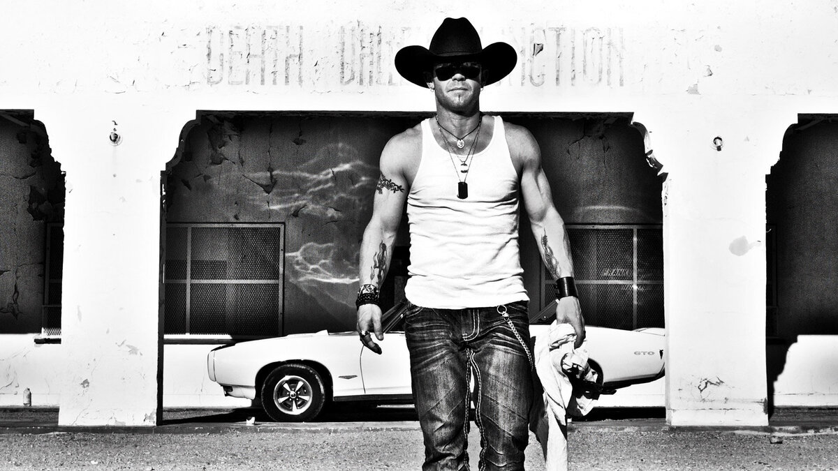 Country Music Photography Aaron Pritchett Death Valley black and white walking toward camera with old convertible GTO behind him