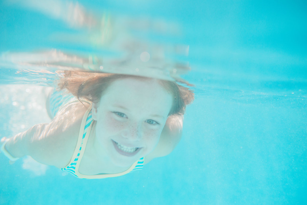 girl smiling underwater