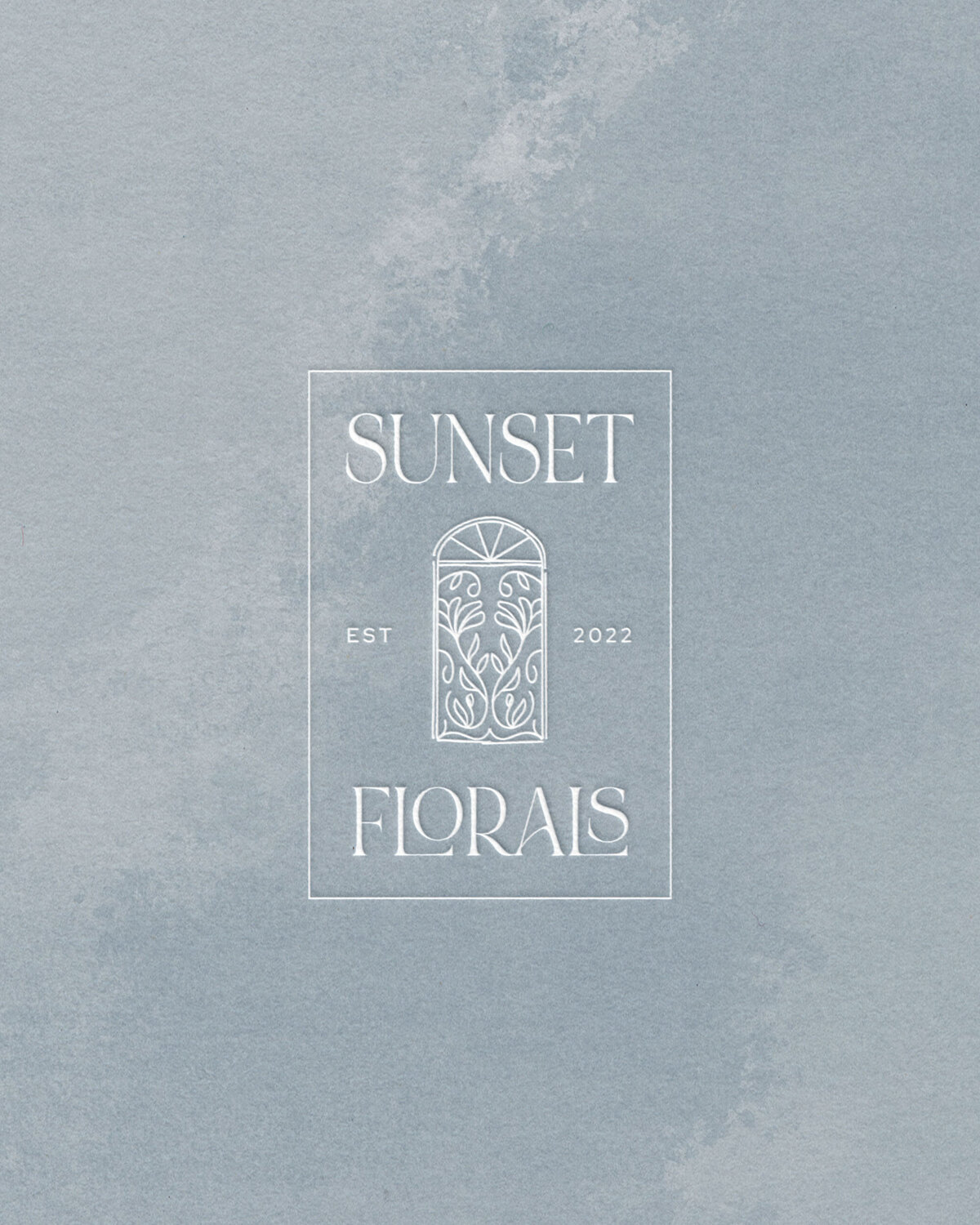 Blue painted texture with Sunset Florals’ submark emblem