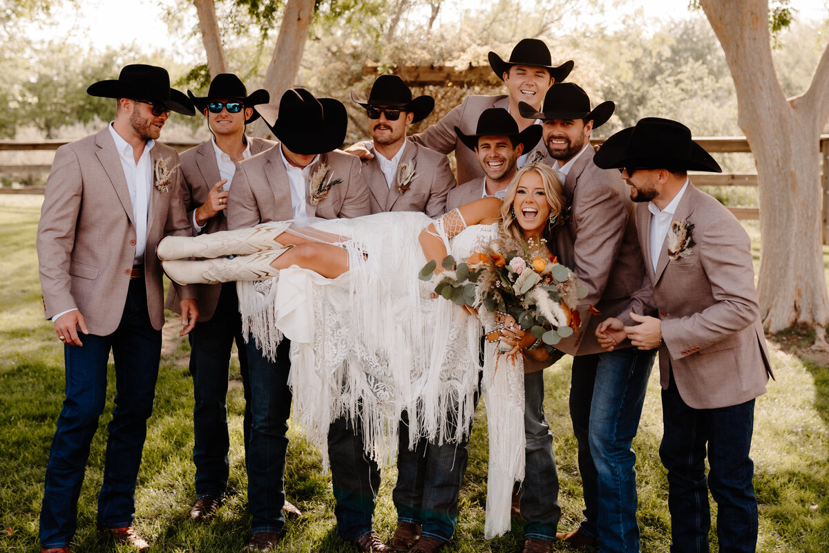 groomsmen holding bride