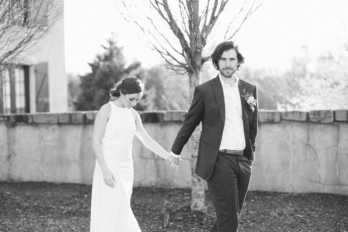 couple holding hands at hotel domestique wedding