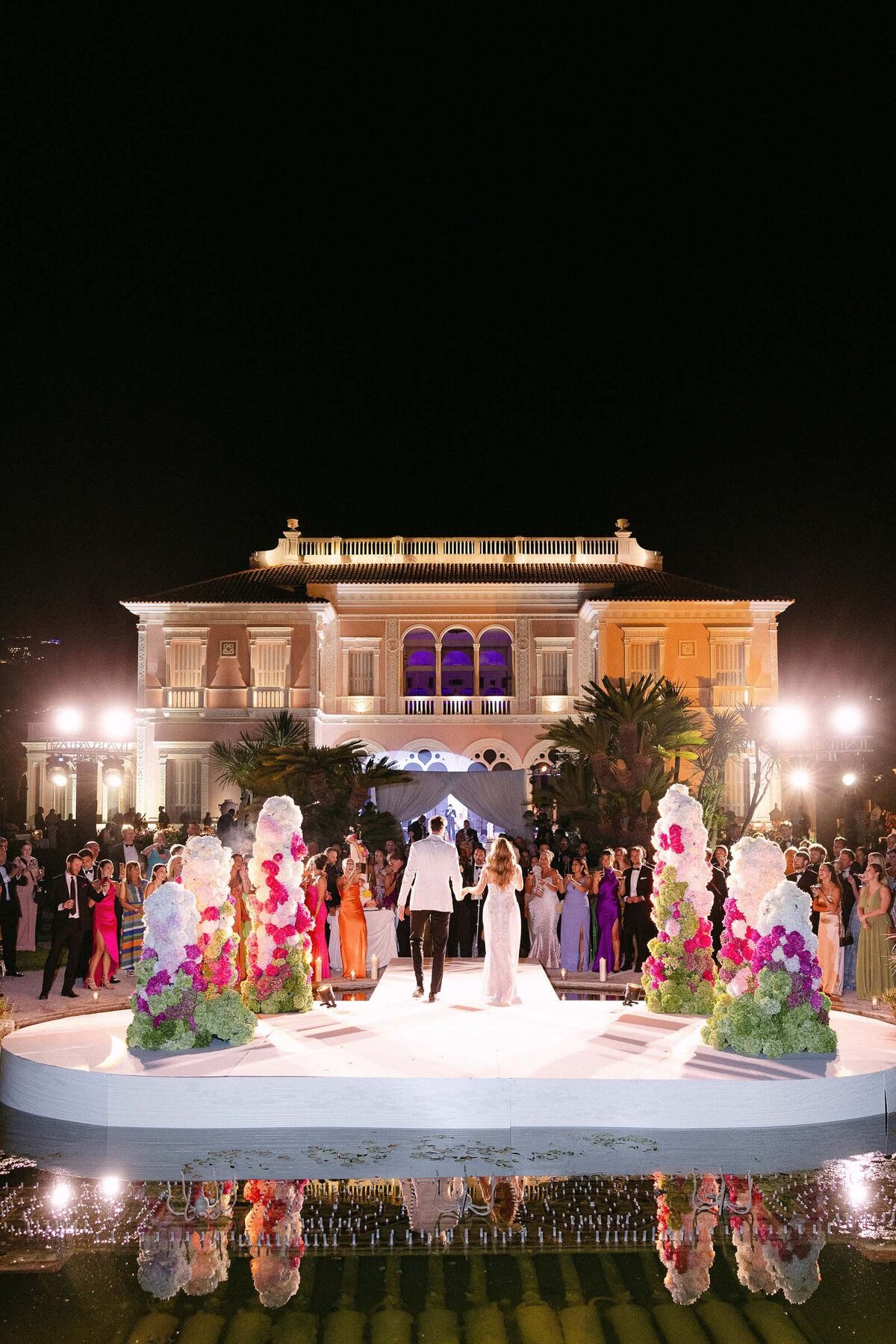 Night shot of the couple making their grand entrance at the wedding reception.