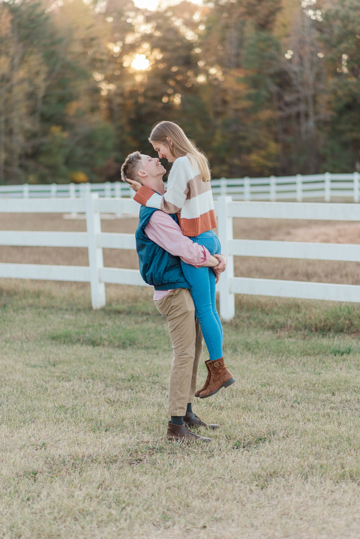 man lifting up woman during portrait photos in Wilmington, NC