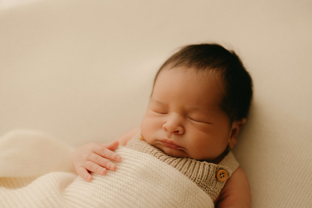 Close-up of newborn swaddled in knit wrap during Nashville Tennessee studio shoot