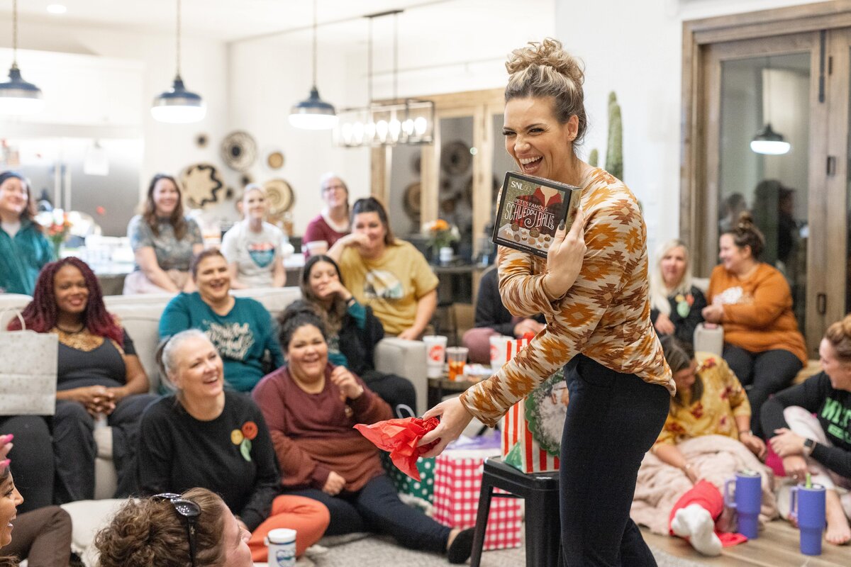 woman laughing at a gift she received