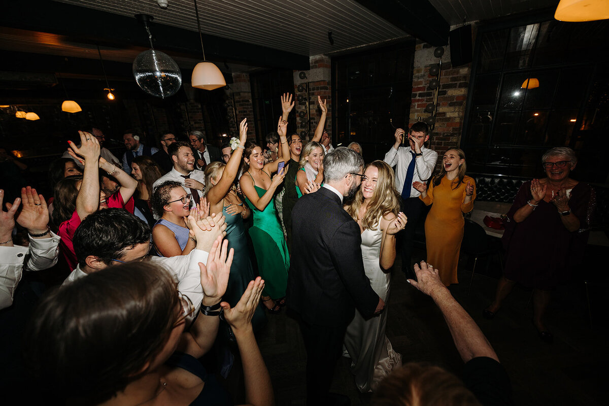Bride and groom on the wedding dance floor surrounded by wedding guests at Roberta's in Dublin, Ireland