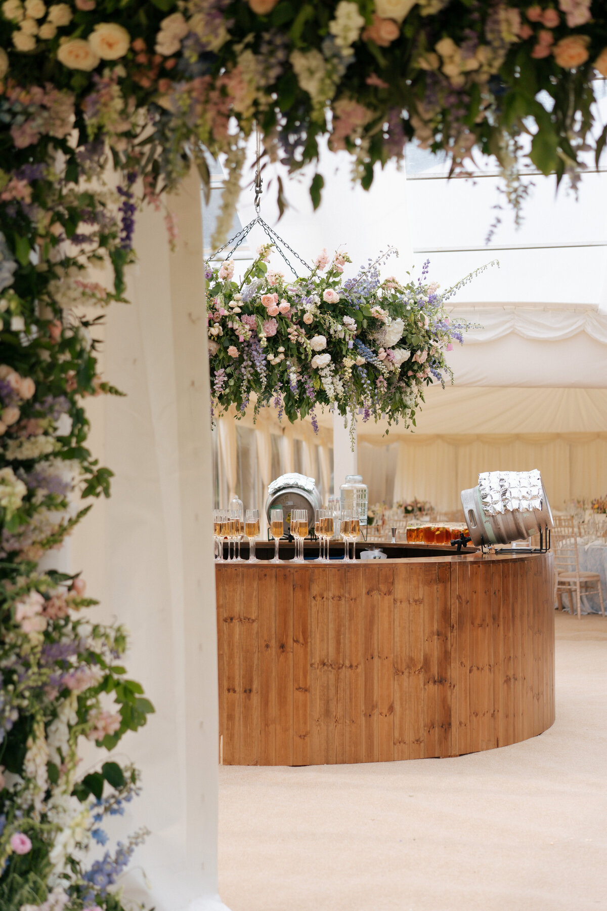 floral arch and hanging flowers summer marquee wedding florist
