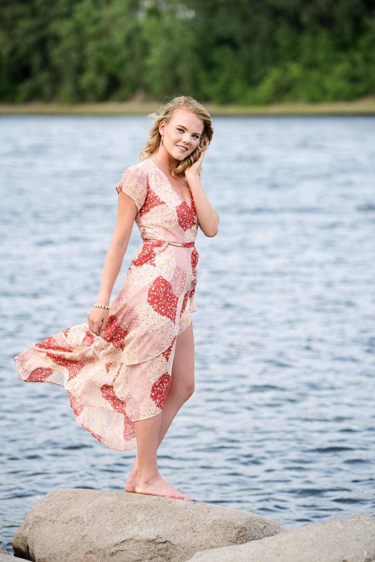 senior photo of maple grove senior in flowing dress on side of river