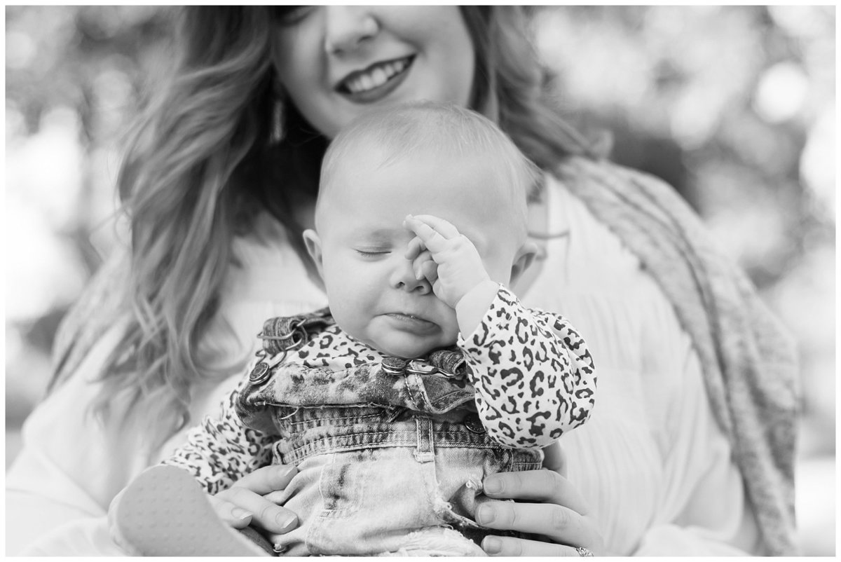 Bowling Green, KY Photographer: Portrait of a baby rubbing her eyes while her mother is holding her.