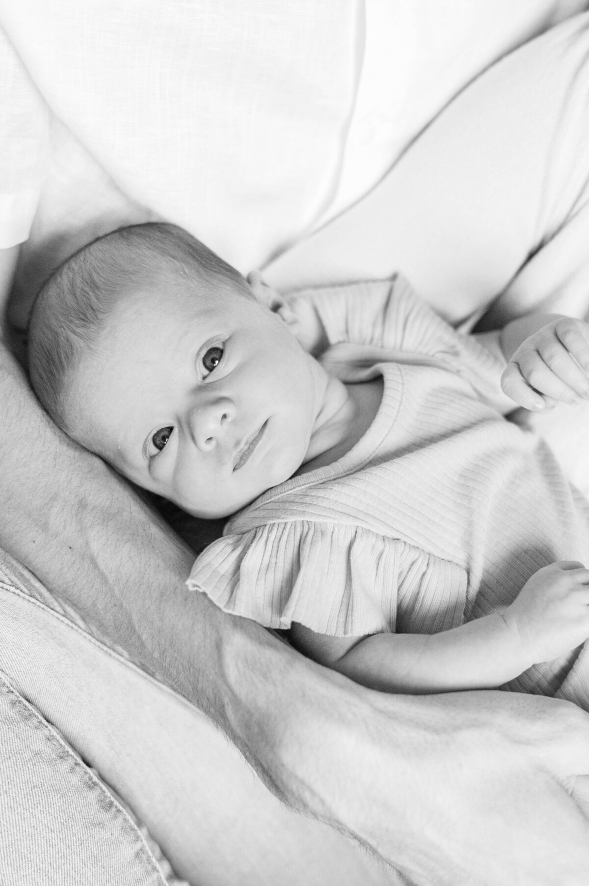 Newborn baby in dad's arms taken in Westwood, MA by best Westwood newborn photographer