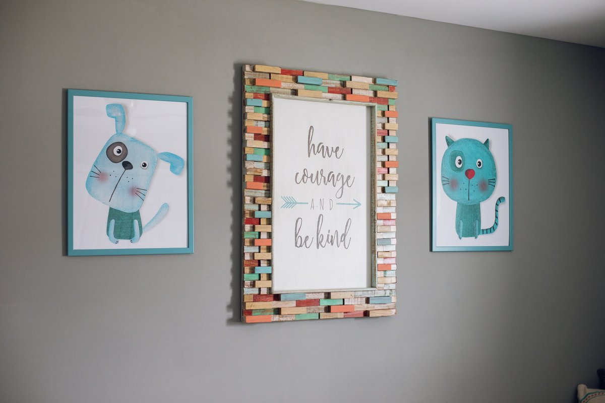 colorful art hanging on the wall of a child's bedroom