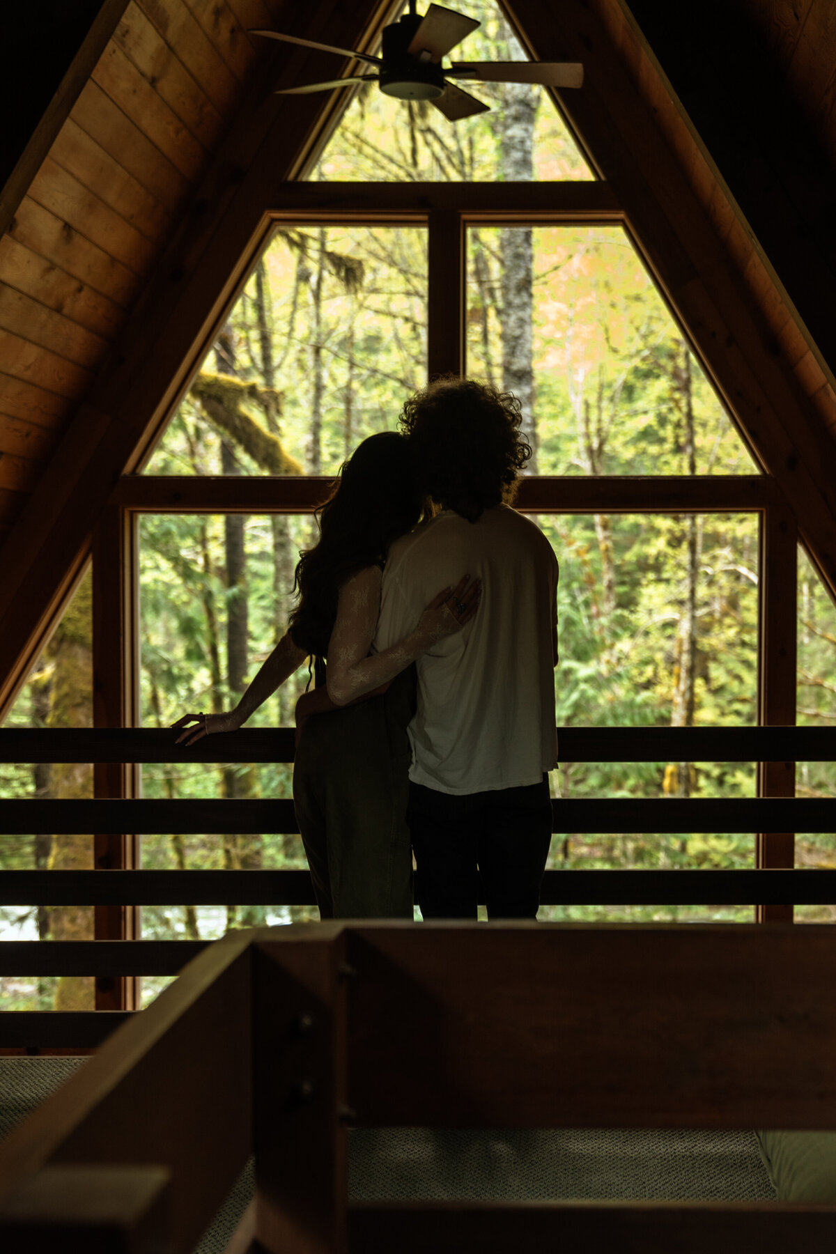 Family gather around a table in a cozy cabin for a winter micro wedding in Vancouver, Washington.