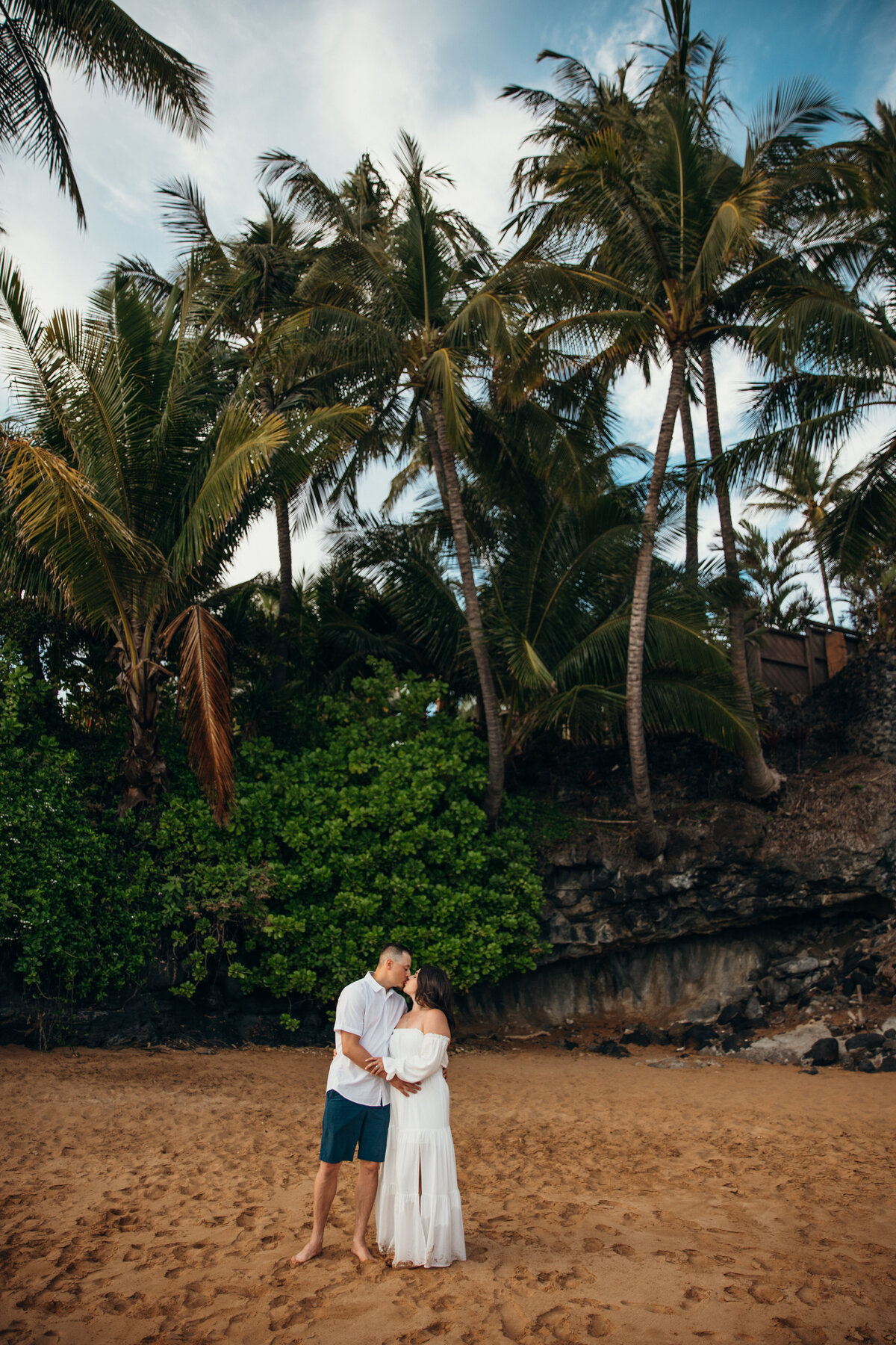 Maui Couples Photographer captures man and woman kissing during beach engagement pictures