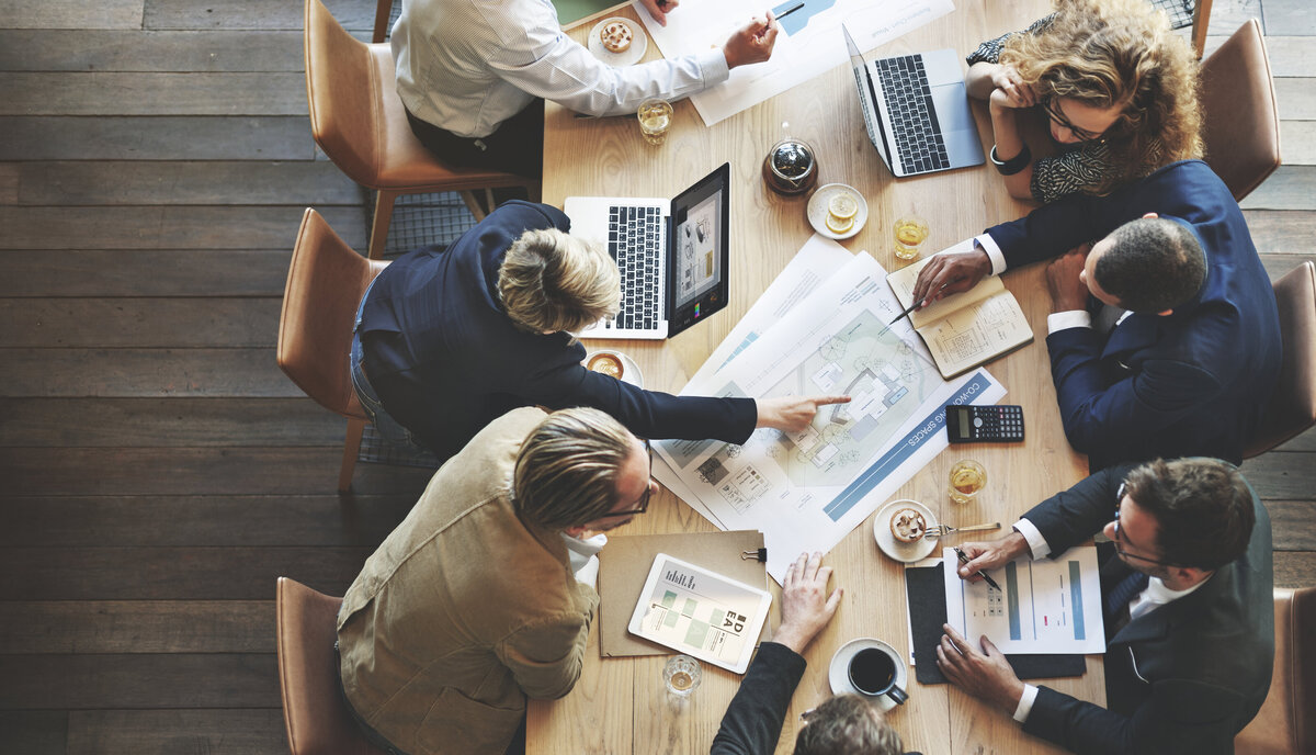 Business owners planning a company structure around a table