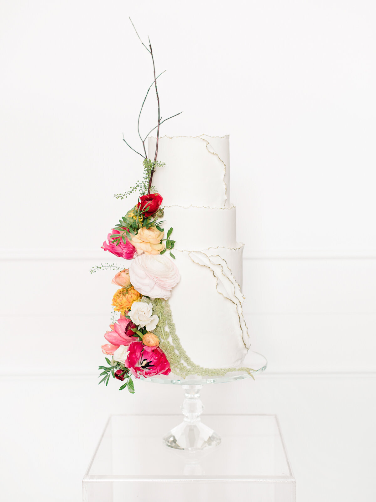 Three-tiered classic white professional wedding cake with modern, vibrant florals, created by Bake My Day, contemporary cakes & desserts in Calgary, Alberta, featured on the Brontë Bride Vendor Guide.