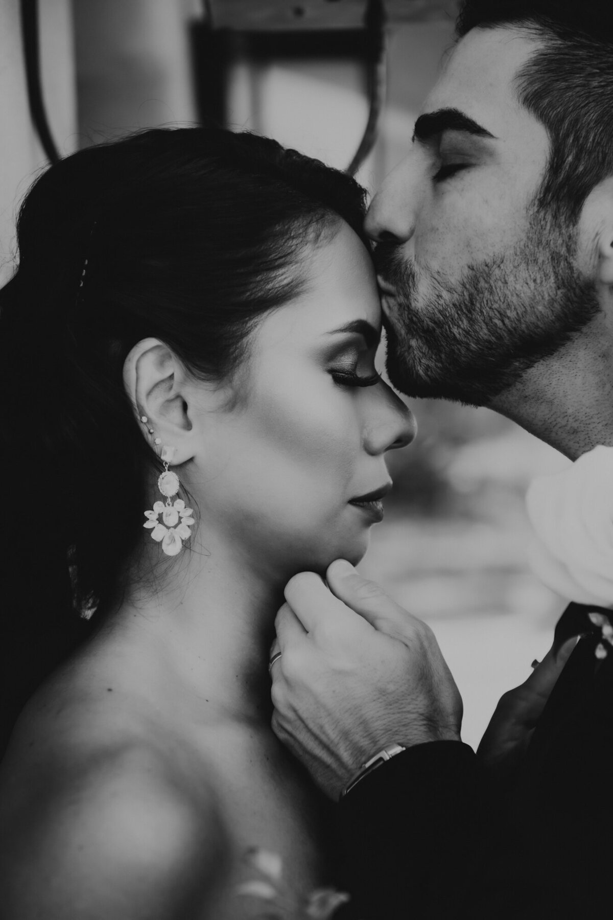 Couples Photographer, A groom kisses a bride on the forehead affectionately