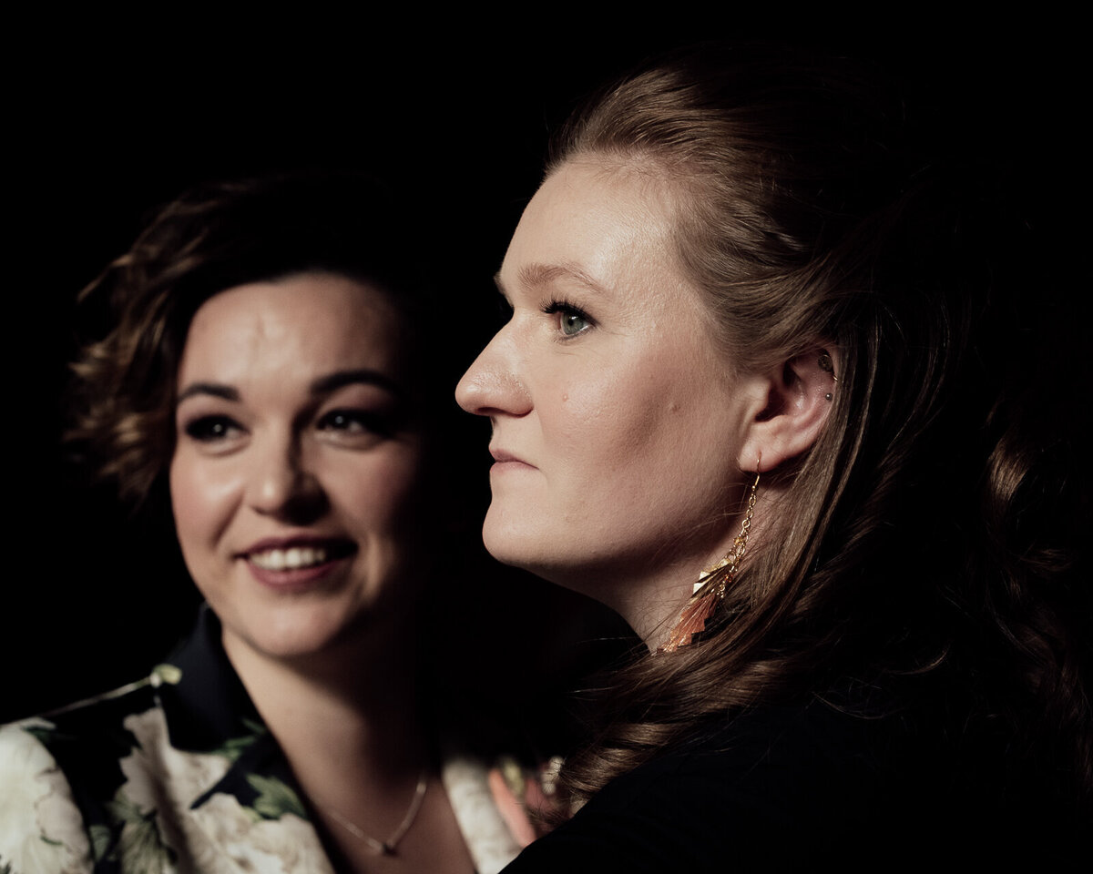 Two brides become emotional during their wedding service.