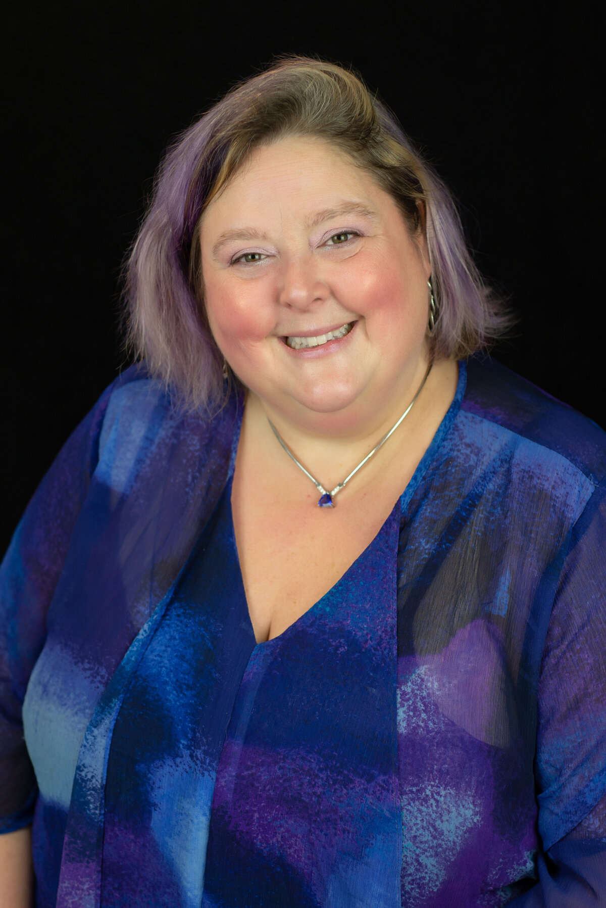 Headshot of woman in purple and blue blouse