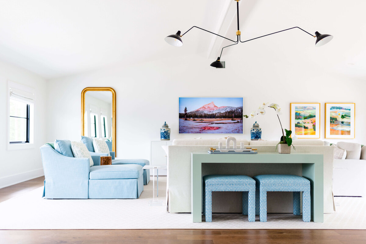 oyster creek studios building belt new build light blue chairs with white sofa and green side table with blue stools in living room