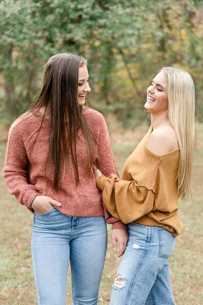 friends laughing while holding each other taken by a Loudoun County, VA senior photographer