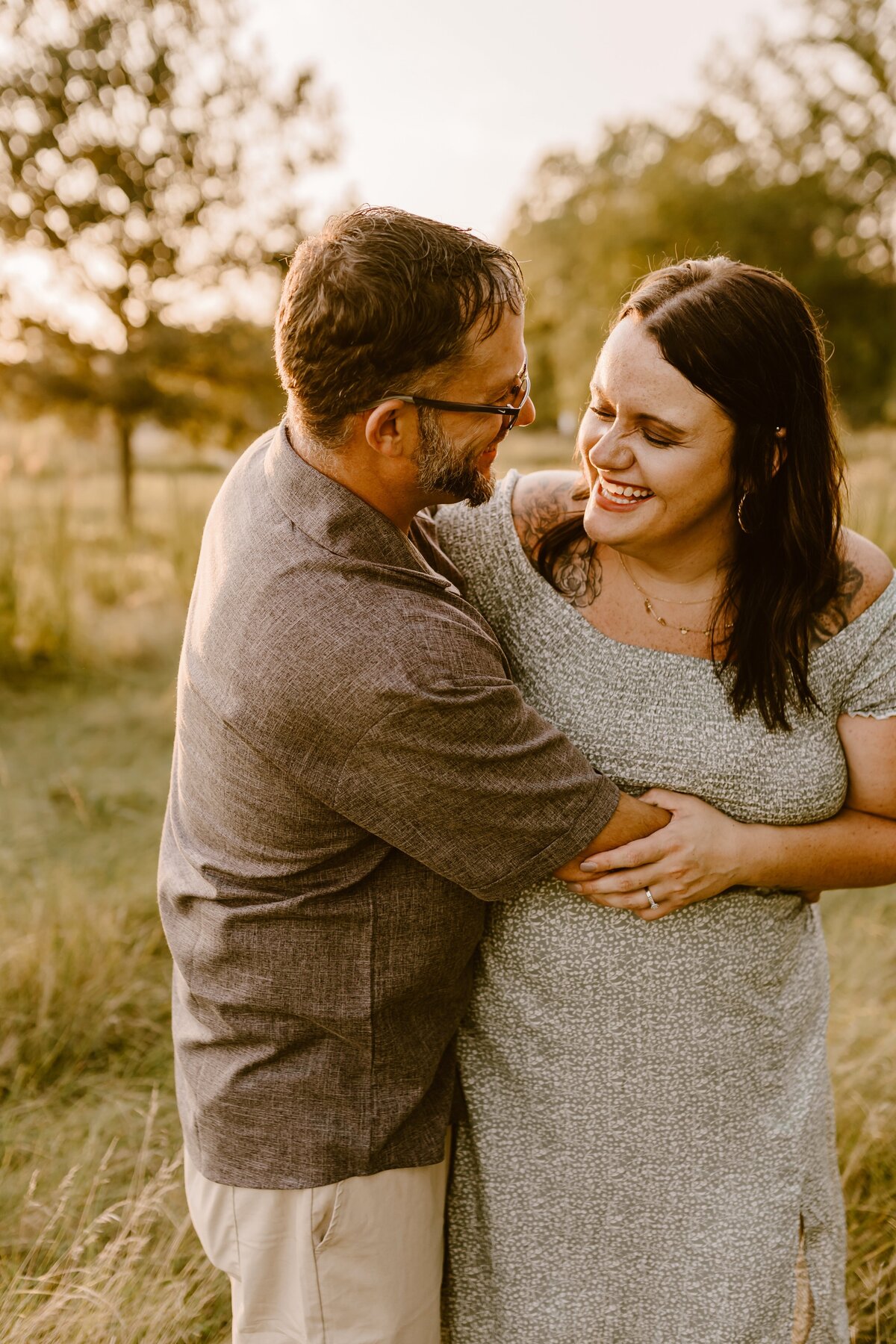 golden-hour-couple-laughing-field-ada-hayden-heritage-park-ames-iowa-storyteller-collective-photo-co