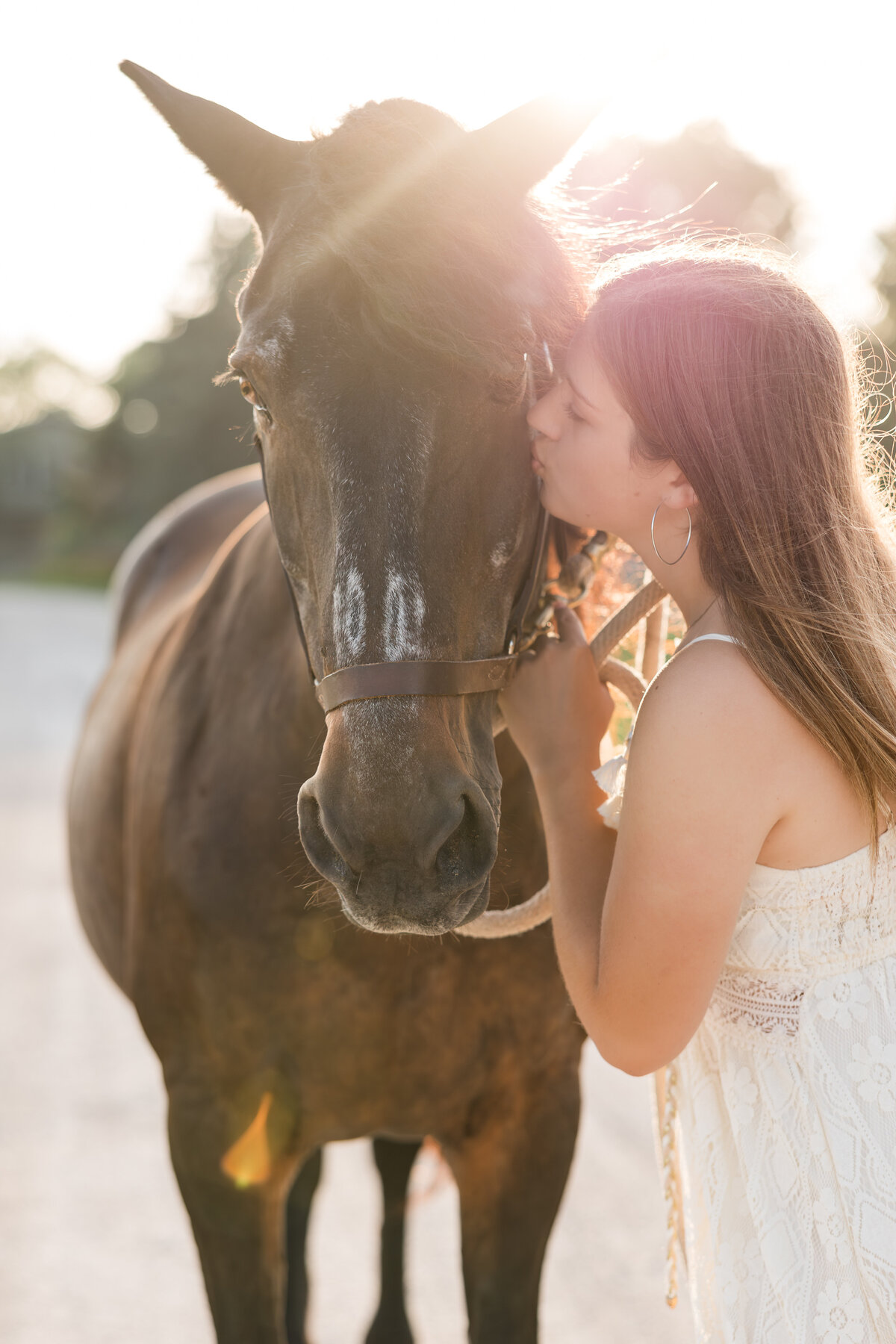 Senior girl kissing her horse