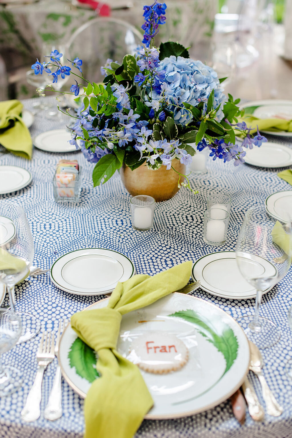 Table setting for wedding at Camargo Club with blue and white linens and florals