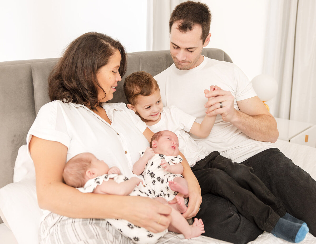 Mother holding newborn during in-home lifestyle photo session in Central Florida


