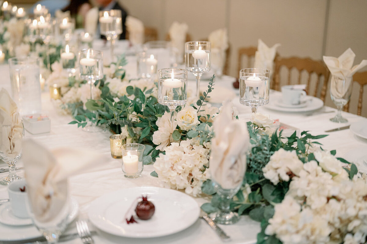 Elegant wedding reception table decor with candles and floral centerpieces at a Dearborn Michigan wedding.
