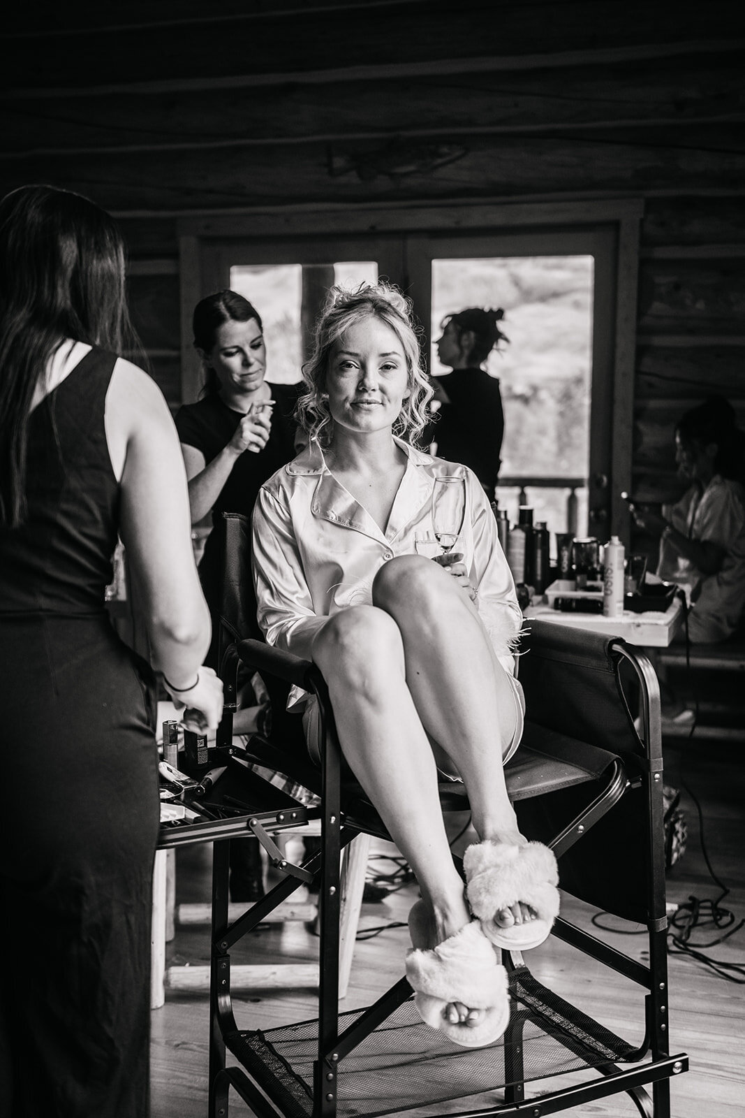Bride relaxing in a chair as she gets her hair and makeup done professionally for her destination wedding weekend 