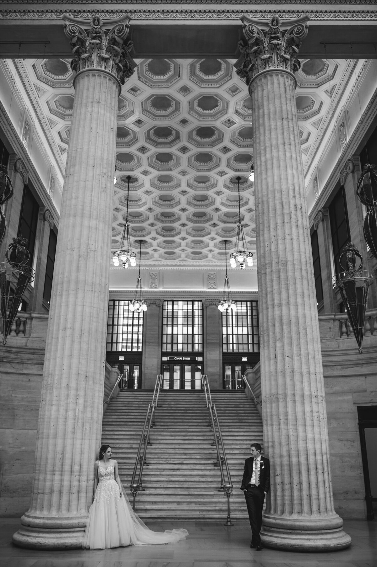 Bride and groom stand in the Chicago Union Station during winter