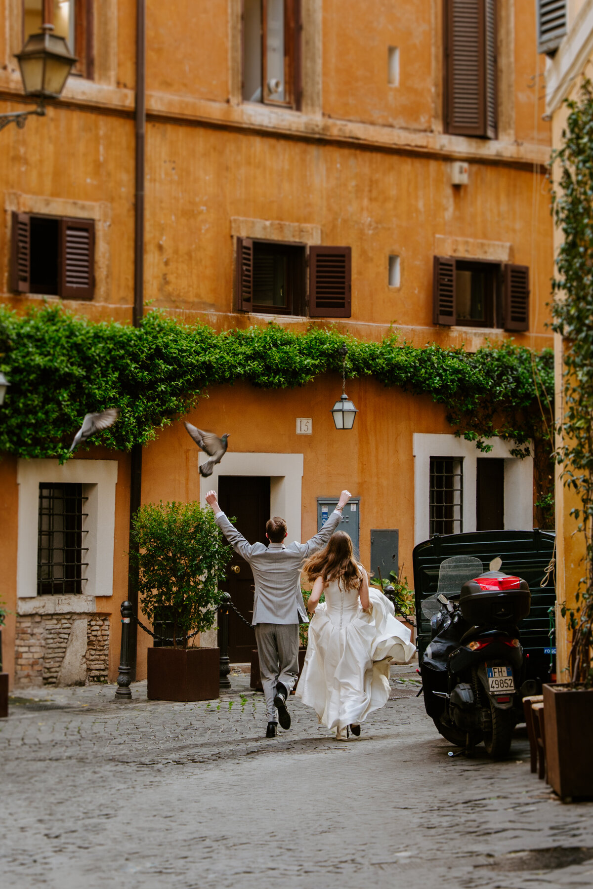 Romantic moment in a narrow Rome alleyway.