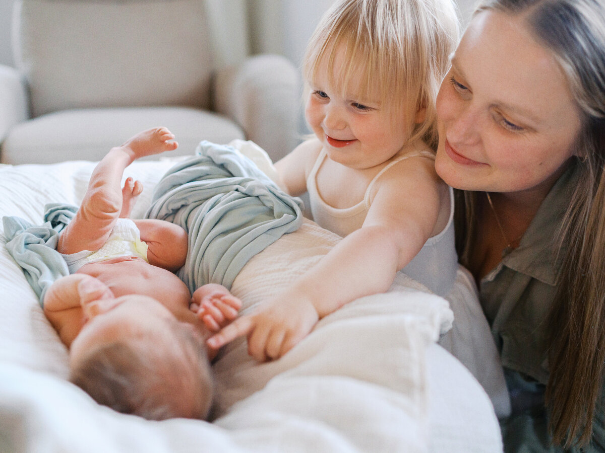 sister-pointing-at-new-baby