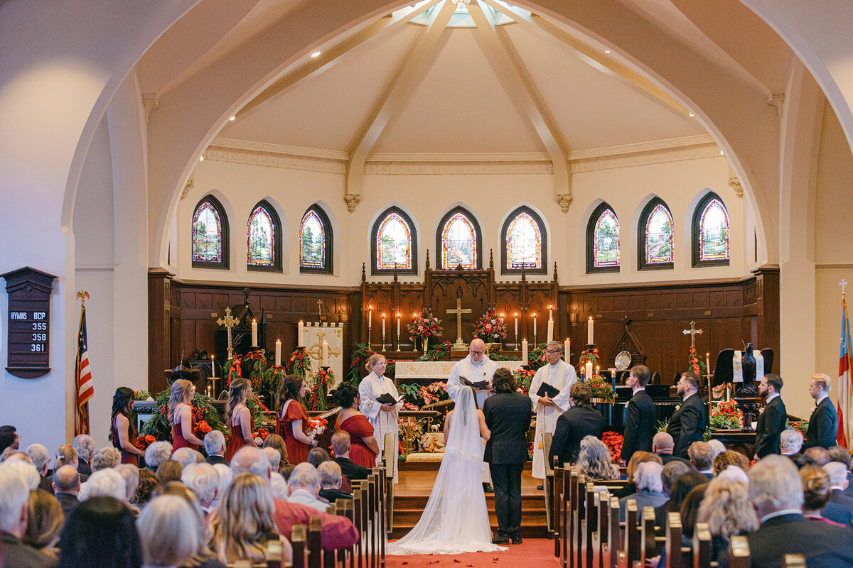 Editorial wide-angle shot of traditional wedding ceremony inside a luxury San Antonio cathedral