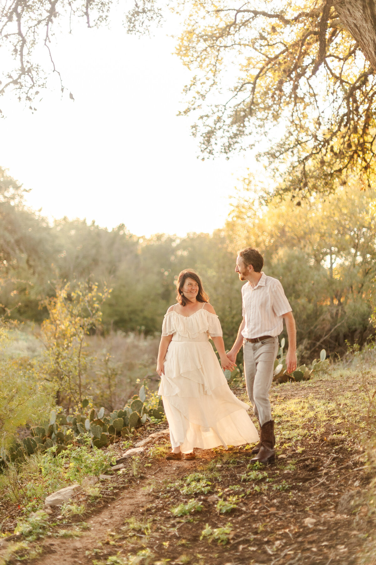 A couple walks together by a creek during their honemoon