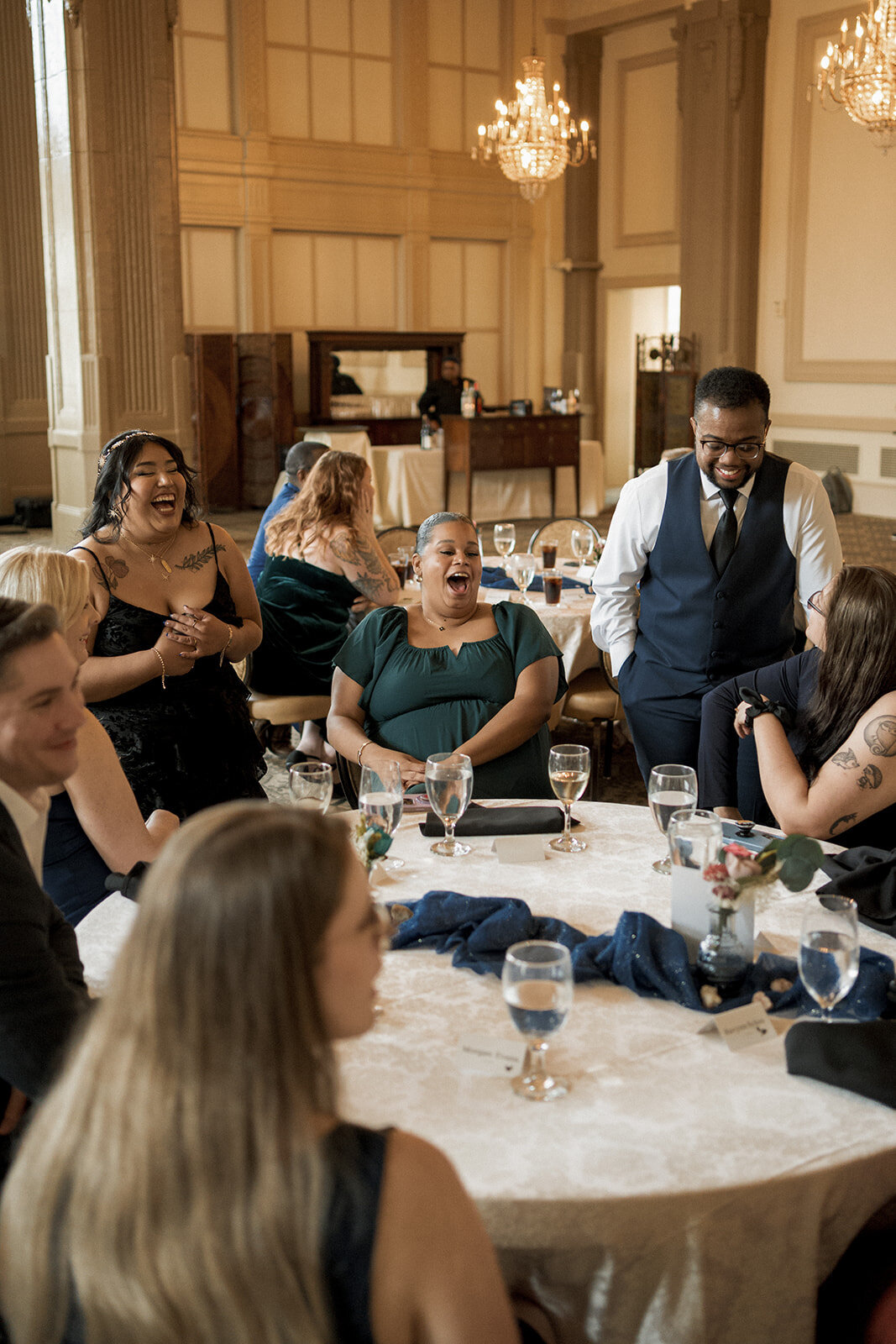 wedding guests laughing at table reception