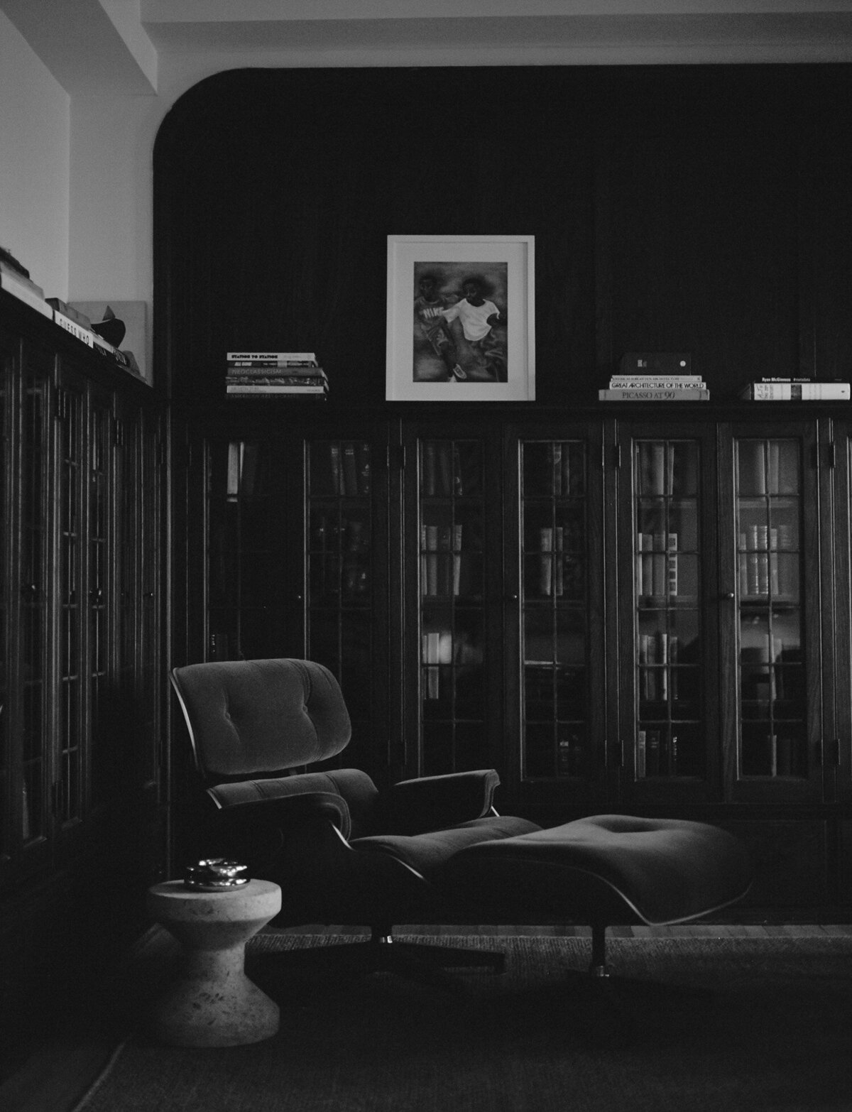 upholstered reclining chair with foot rest, bookshelves, interior film photography at ALEO Detroit